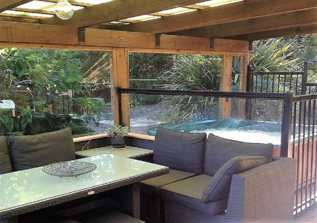 a patio with a table and a hot tub at Sutton Spring Art Retreats in Daylesford