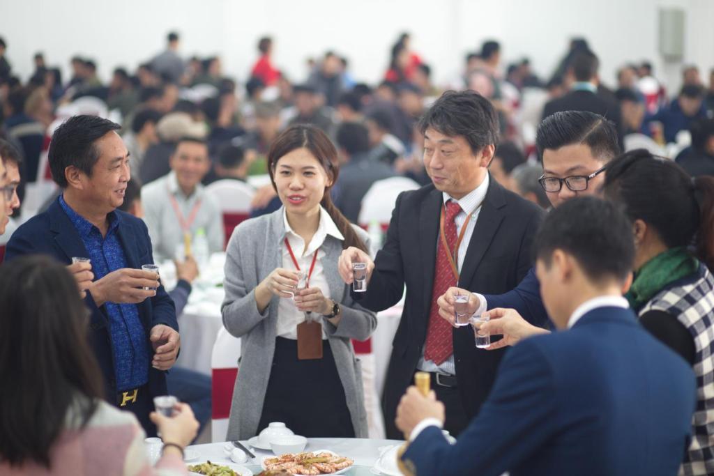 a group of people standing around a table with wine glasses at Windsor Hotel Son La in Sơn La