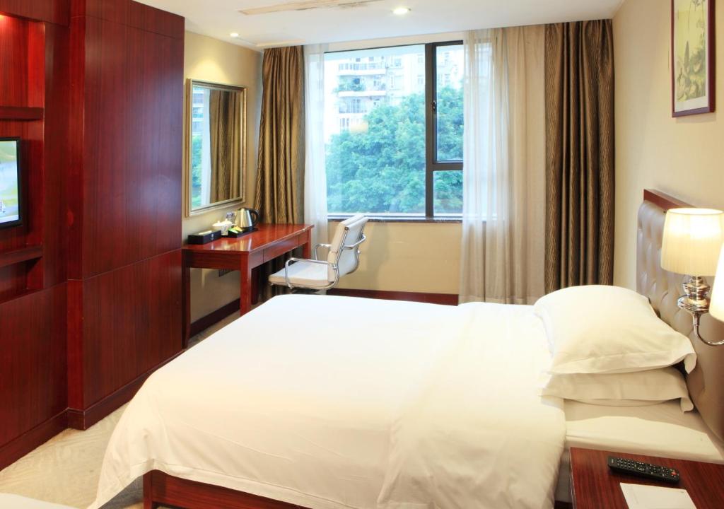 Postel nebo postele na pokoji v ubytování Guangzhou Shi Liu Hotel