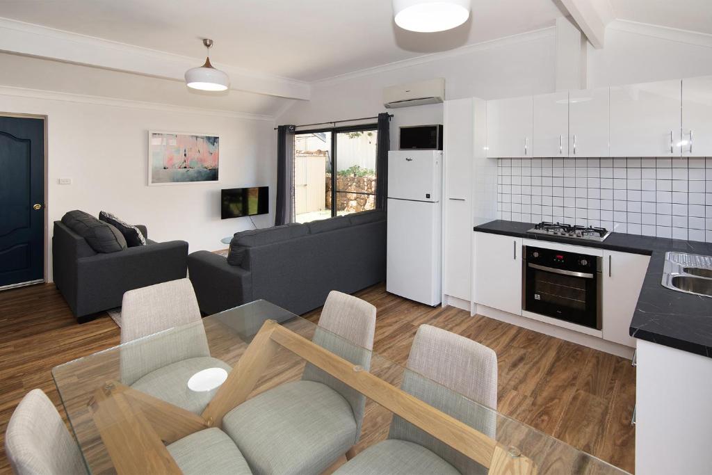 a kitchen and living room with a table and chairs at Tootys Place in Margaret River Town