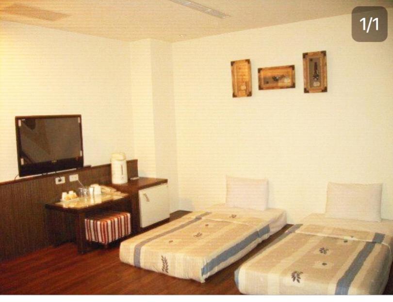 Postel nebo postele na pokoji v ubytování Good Ground Hotel Tainan
