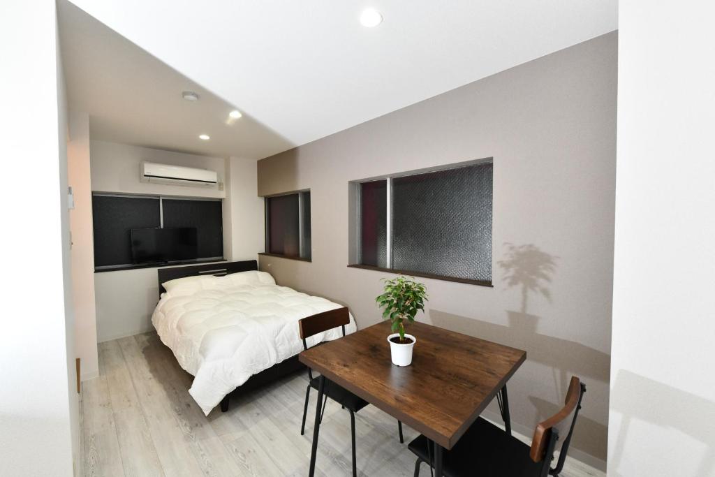 Postel nebo postele na pokoji v ubytování Suzumaru Hotel