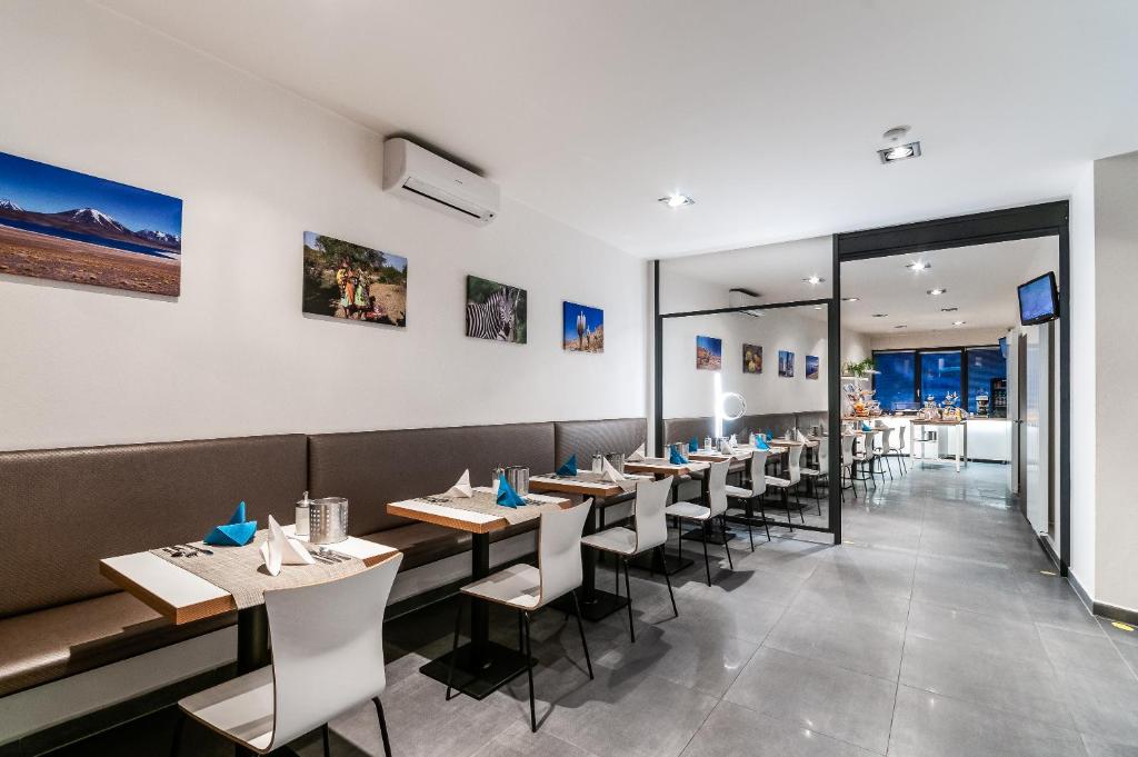 a restaurant with tables and chairs in a room at VV hotel & apartments in Brno