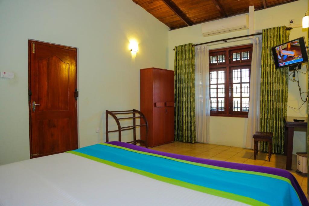 Postel nebo postele na pokoji v ubytování Kandyan Hideout