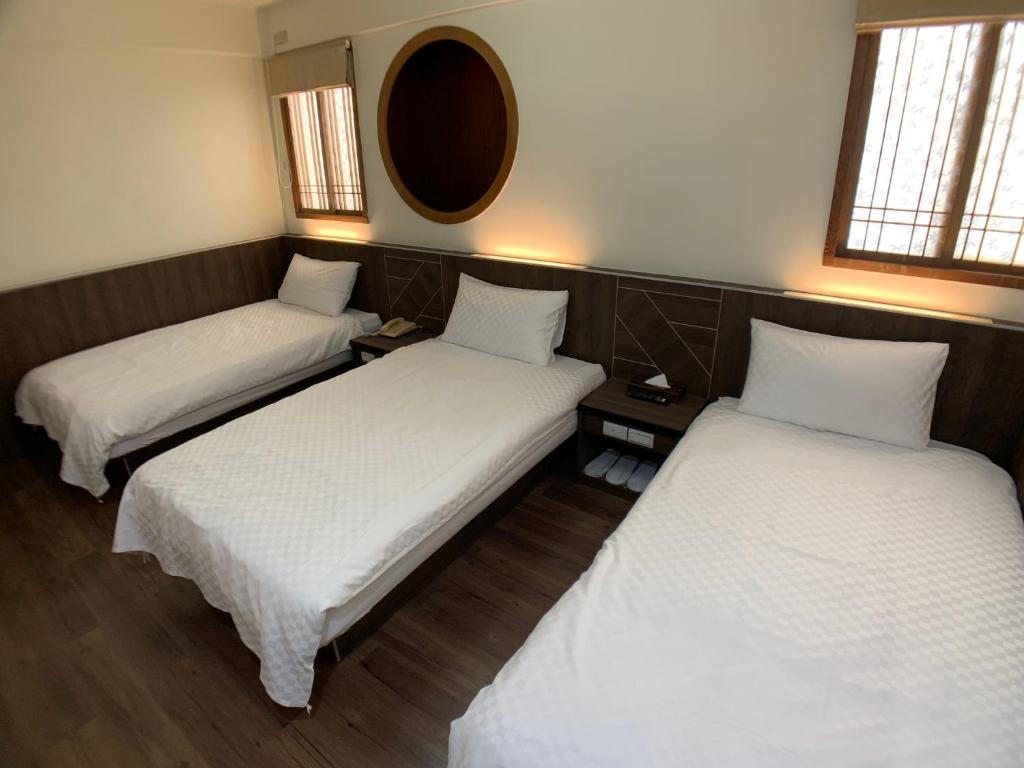 Postel nebo postele na pokoji v ubytování Penghu An-I Hotel