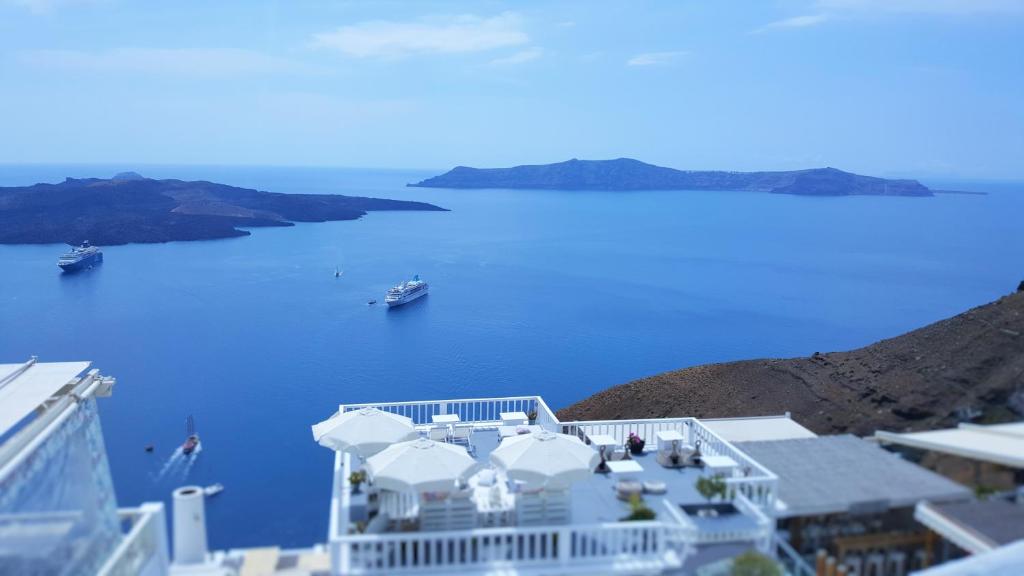 a view of the blue ocean from the top of a building at Katris Apartments in Fira