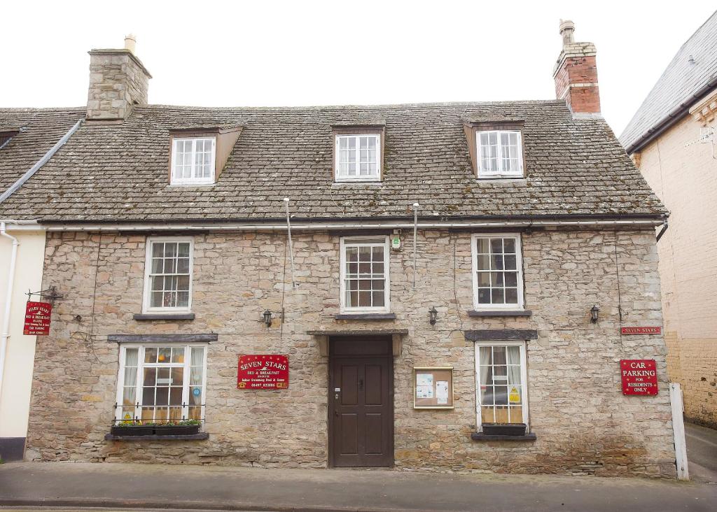 an old stone building with a brown door at Seven Stars in Hay-on-Wye
