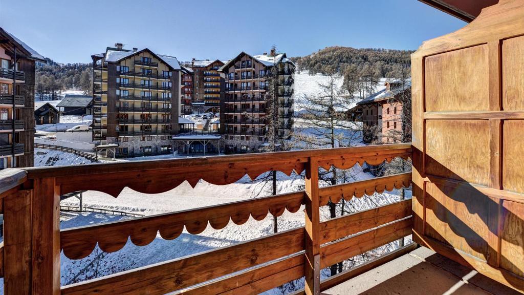 a balcony with a view of a snowy city at Vacancéole - Résidence Vega in Risoul