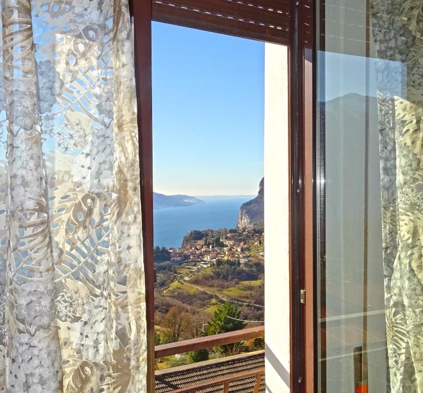 a window with a view of the ocean at Casa Palanca Lake view apartment by Gardadomusmea in Tremosine Sul Garda