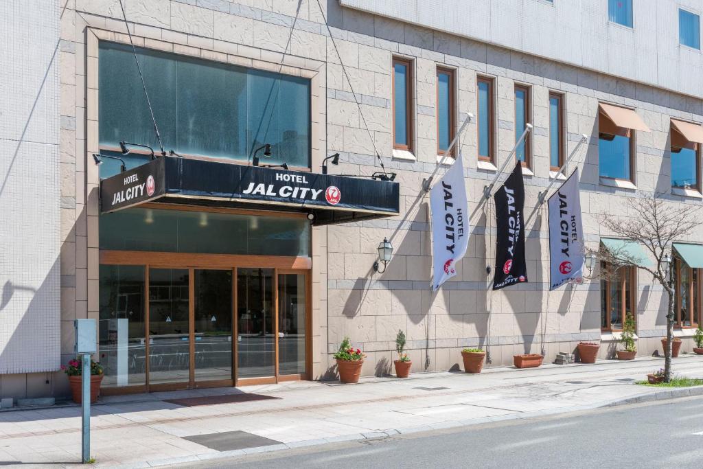 a building with a sign on the side of it at Hotel JAL City Aomori in Aomori