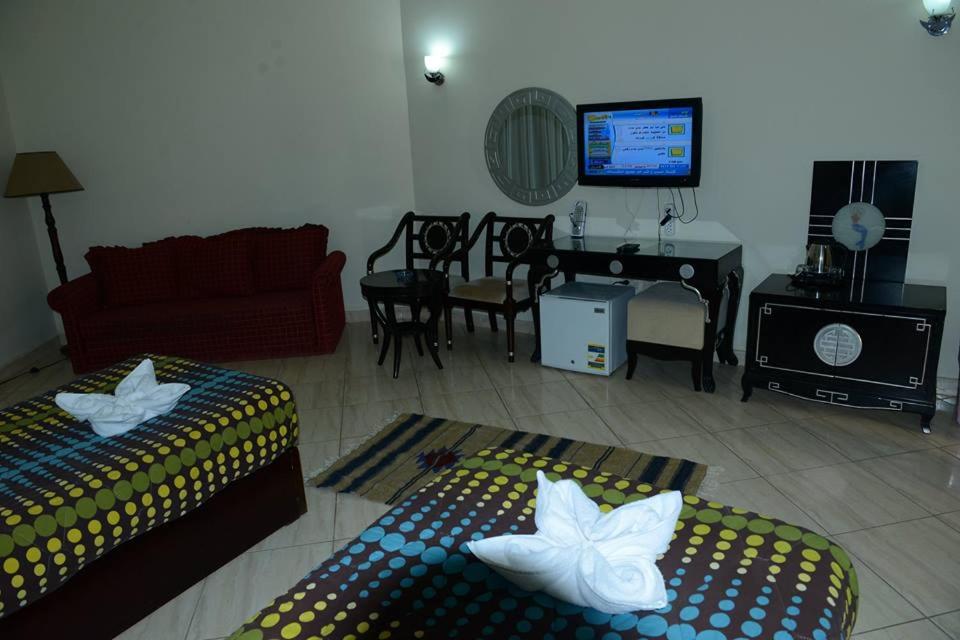 A television and/or entertainment centre at La Sirena Hotel & Resort - Families only