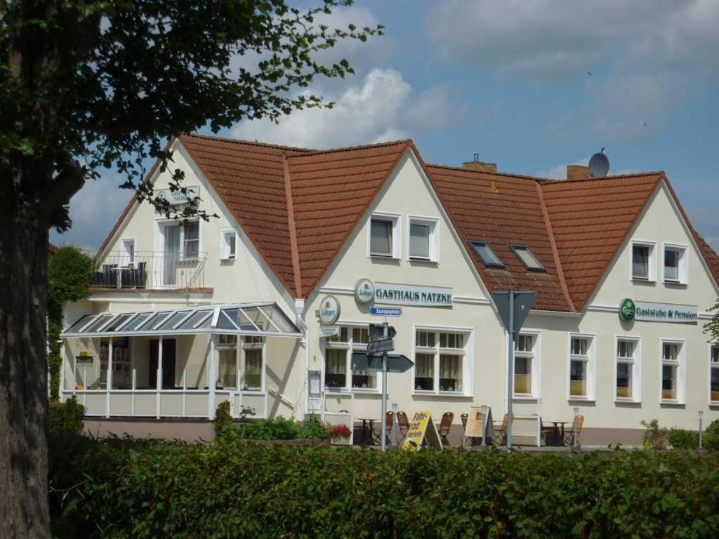 a large white building with a red roof at Gasthaus Natzke in Usedom Town