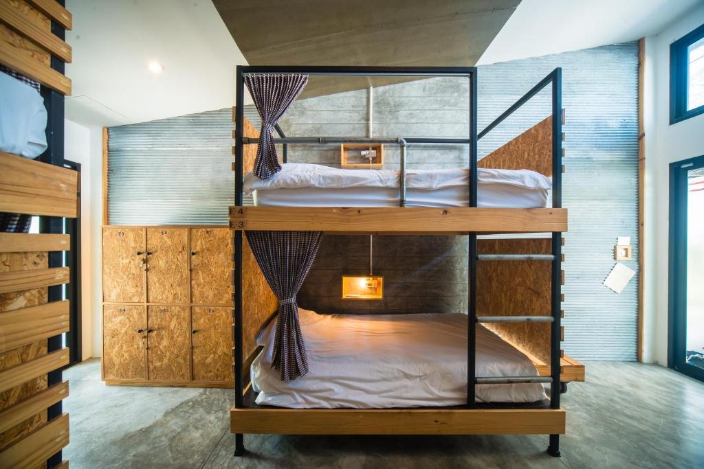 two bunk beds in a small room with a room at ChillHub Hostel Phuket in Bang Tao Beach