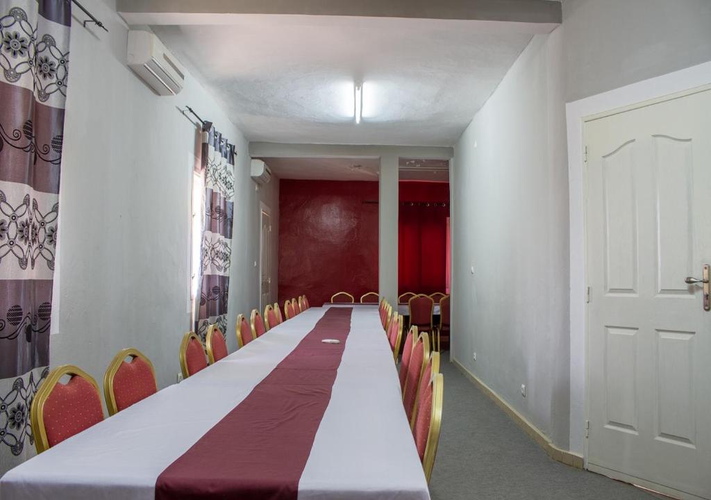 a long table in a room with chairs at Melia Hotel in Saly Portudal