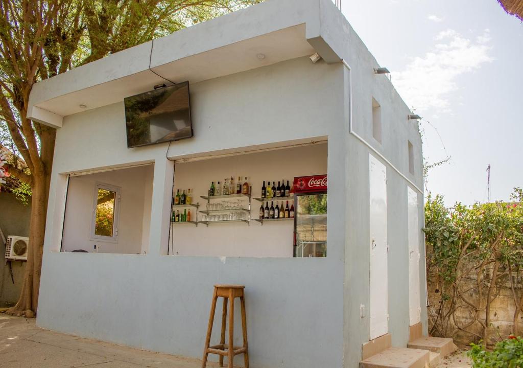 a small white building with a stool in front of it at Melia Hotel in Saly Portudal
