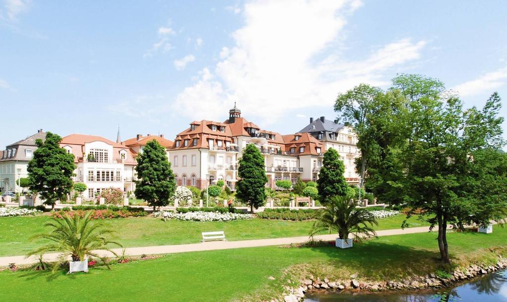 a large building with a park in front of it at Hotel Residenz am Rosengarten in Bad Kissingen