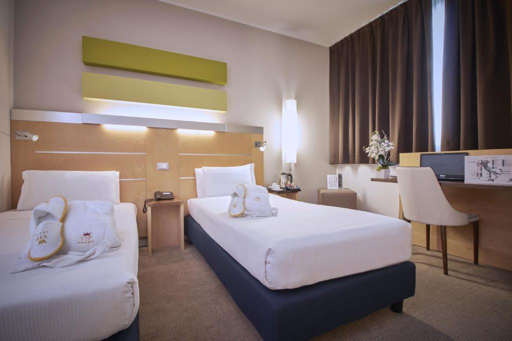 Postel nebo postele na pokoji v ubytování iH Hotels Milano Gioia