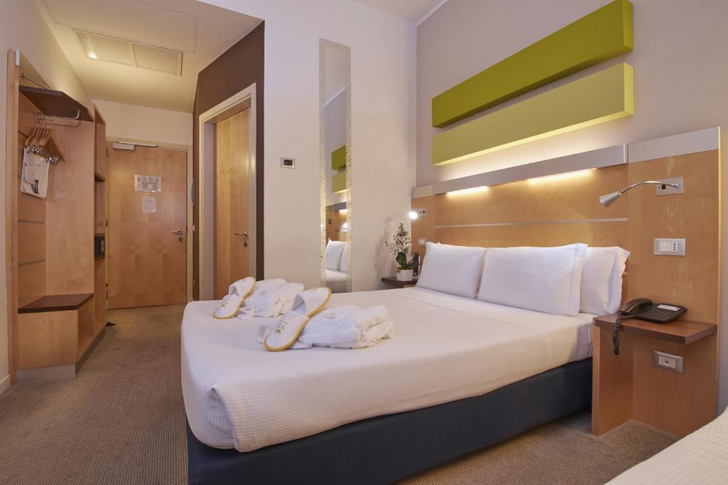 Postel nebo postele na pokoji v ubytování iH Hotels Milano Gioia