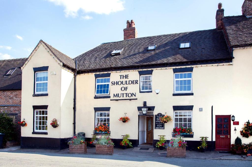 a white building with a sign that reads the squirrel of mirror at The Shoulder Of Mutton Inn in Hamstall Ridware