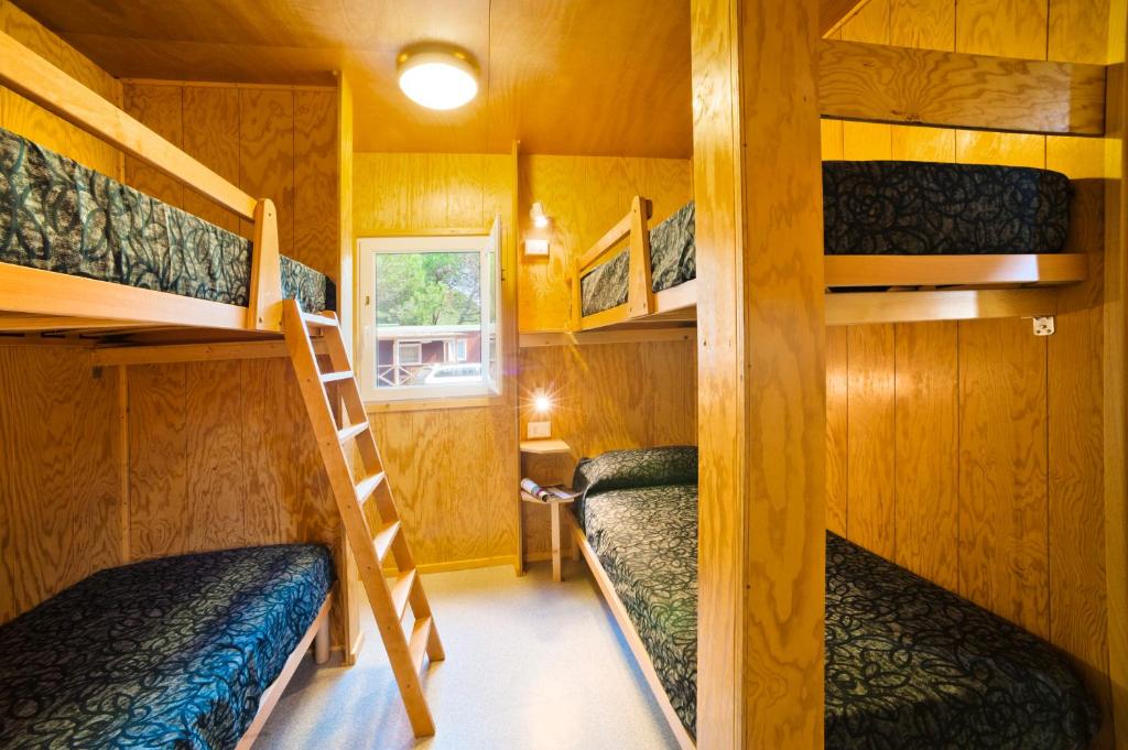 a room with bunk beds in a tiny house at Camping Lido in Bibione