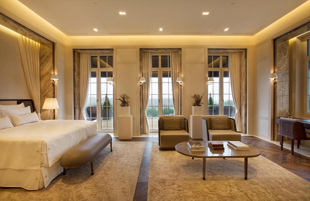 a bedroom with a bed and a couch and a table at Kemer Country Hotel İstanbul in Istanbul