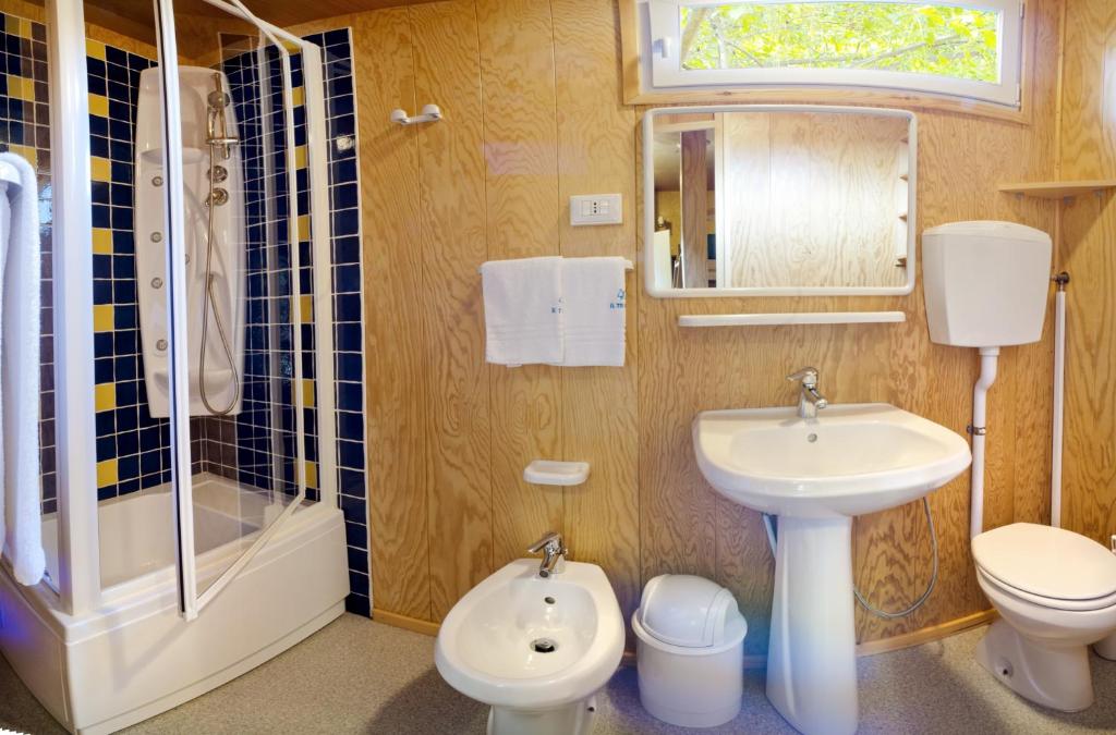 a bathroom with a sink and a toilet and a shower at Camping Village Capalonga in Bibione