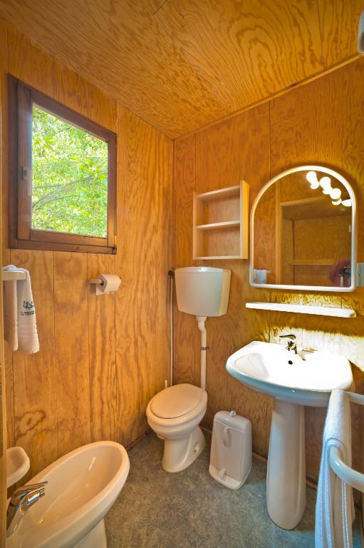 a bathroom with a toilet and a sink and a mirror at Camping Village Capalonga in Bibione