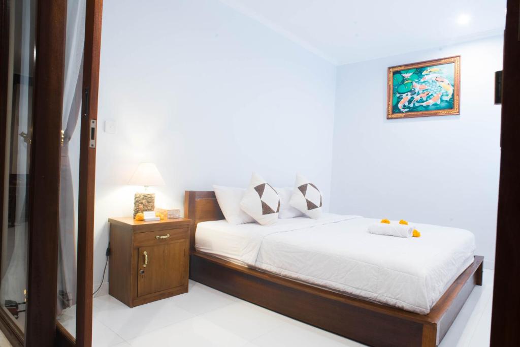 Postel nebo postele na pokoji v ubytování Suntari Homestay