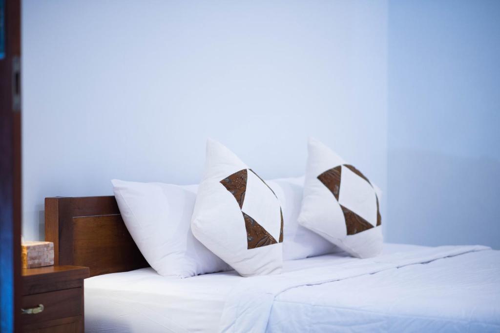 Postel nebo postele na pokoji v ubytování Suntari Homestay