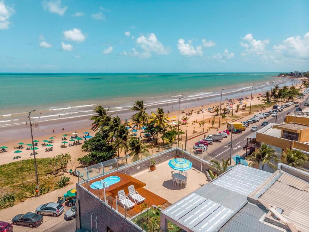 an aerial view of a beach with cars and people at Bessa Golden Flats in João Pessoa