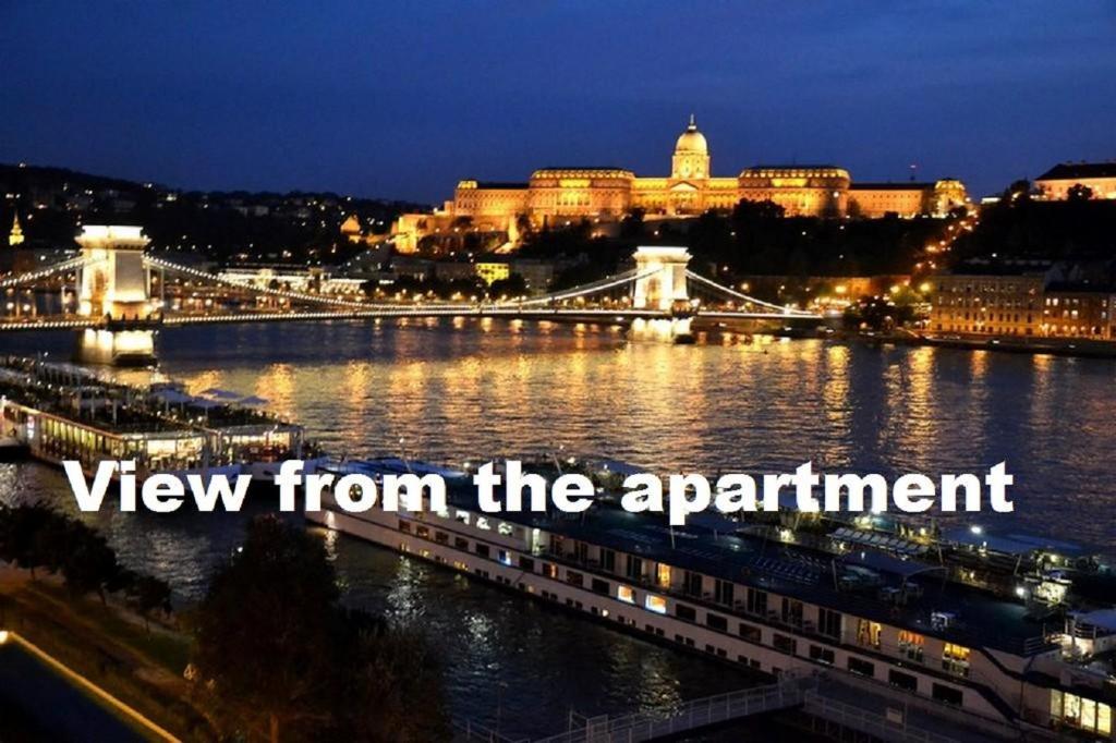 a view of a bridge over a river at night at Apartment Castle View in Budapest