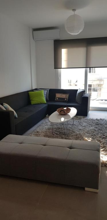 a living room with a couch and a coffee table at Cozy Flat in the heart of North Nicosia --- 55-1 in Lefkosa Turk