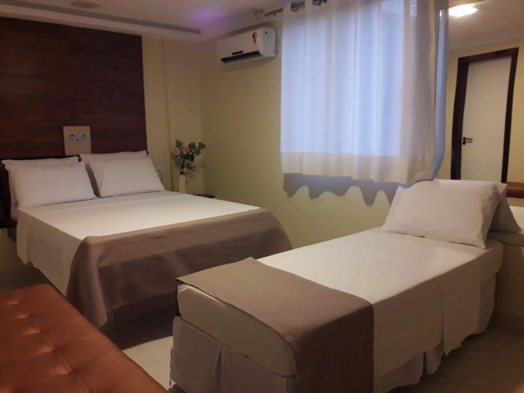 Postel nebo postele na pokoji v ubytování Hotel Sempre Executive