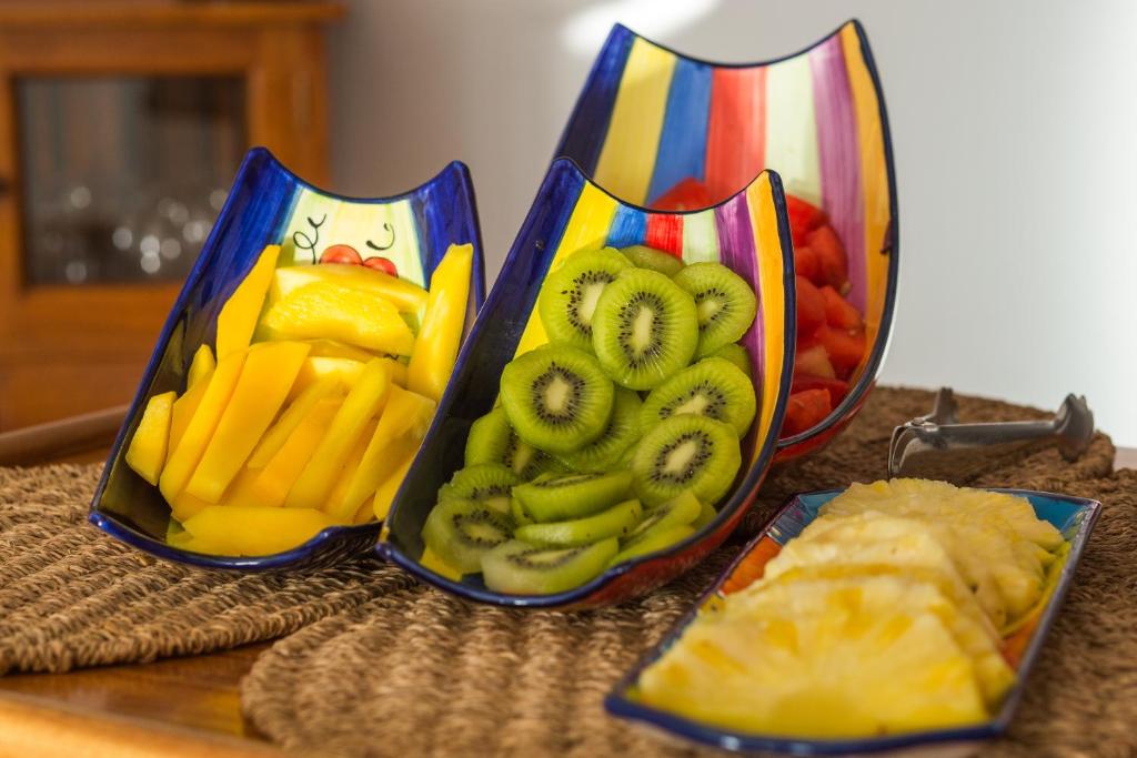 two containers filled with fruits and vegetables on a table at Boutique Hotel El Tio Kiko in Agua Amarga