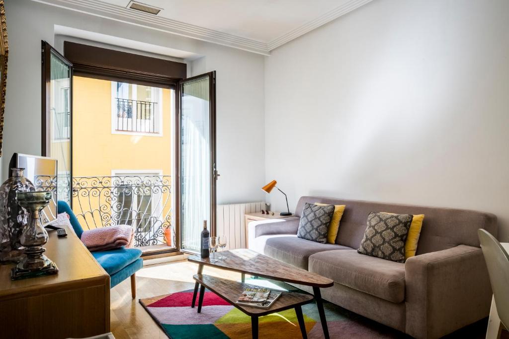 a living room with a couch and a table at Figueroa Design in Madrid