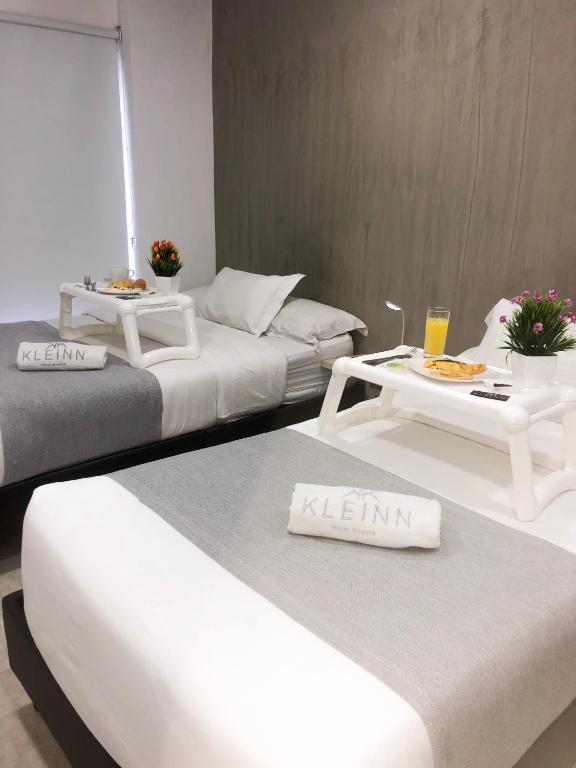 Postel nebo postele na pokoji v ubytování KLEINN HOTEL BOGOTÁ