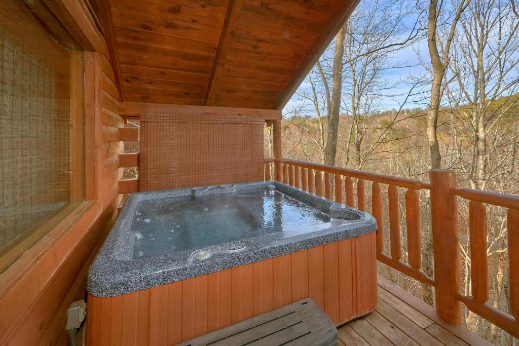 a hot tub on the deck of a cabin at Hanky Panky in Pigeon Forge