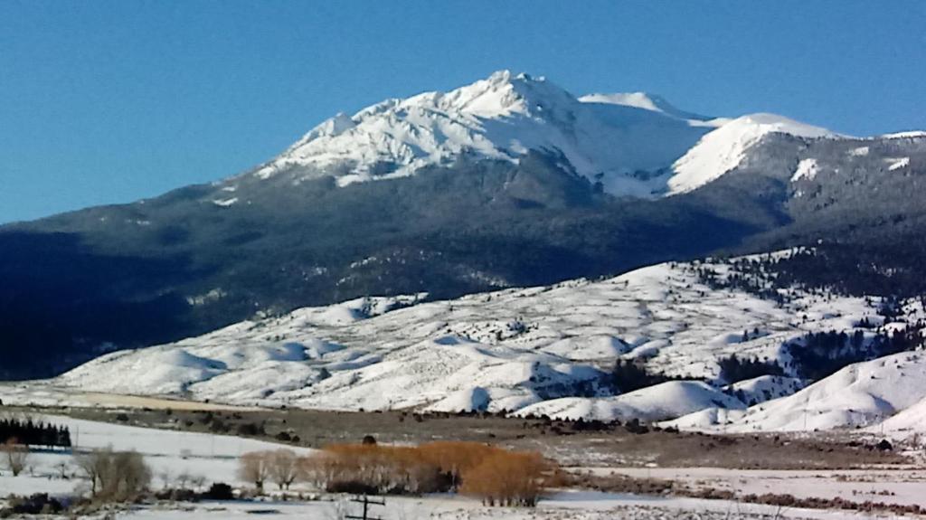 a snow covered mountain in front of a snow covered mountain at Yellowstone Basin Inn in Gardiner