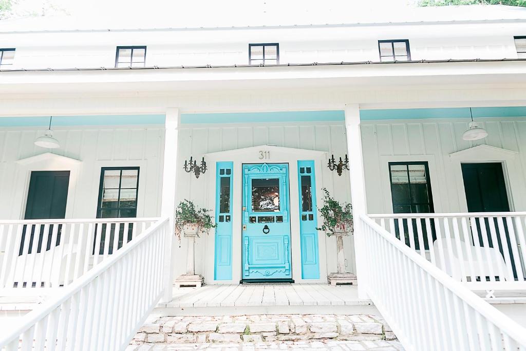 a blue front door on a white house at The Frenchie in Round Top