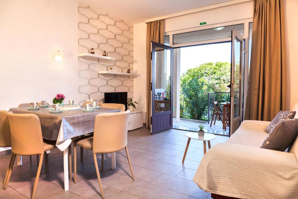 a living room with a dining room table and a couch at Apartment Villa Lidija in Lovran