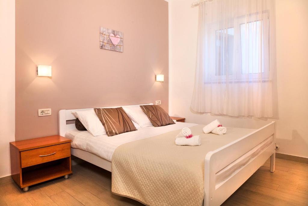 a bedroom with a bed with two towels on it at Apartment Villa Lidija in Lovran
