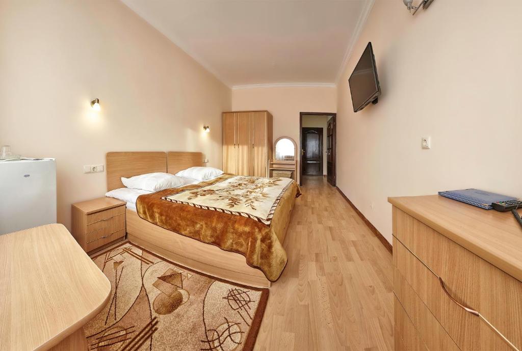 Postel nebo postele na pokoji v ubytování Resort Hotel Karpaty