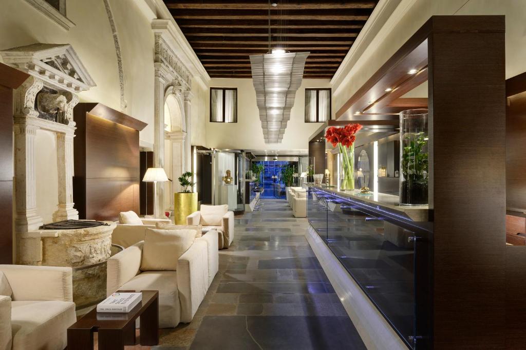 a lobby of a hotel with white furniture at Hotel Palazzo Giovanelli e Gran Canal in Venice