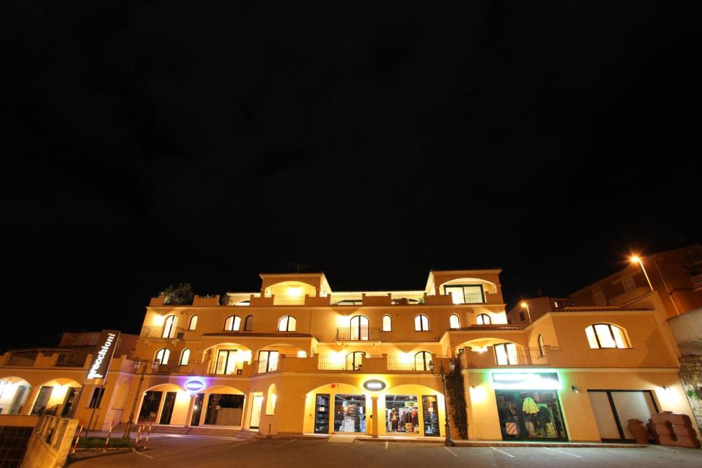 a large building is lit up at night at Leberides in La Maddalena