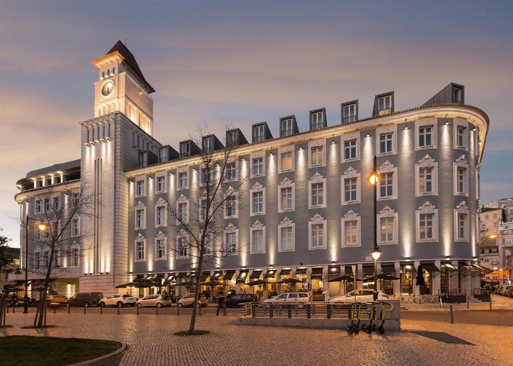 a large building with a clock tower on top of it at Lisbon Finestay 8 Building Apartments in Lisbon