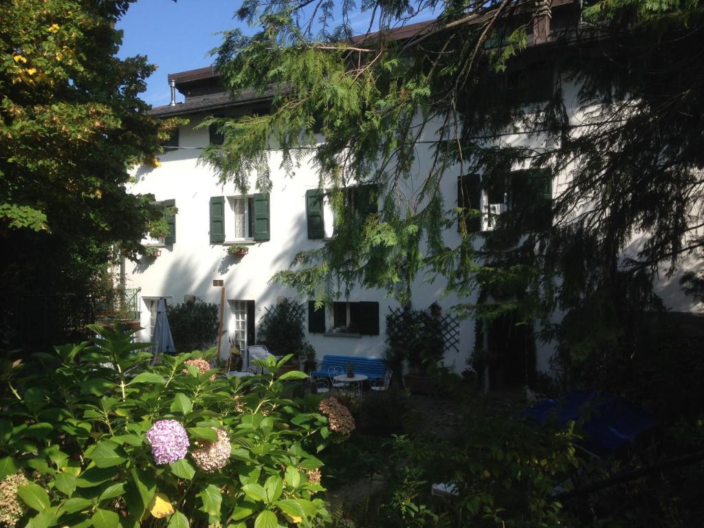a white house with a garden in front of it at Villa Fedora in Lizzano in Belvedere