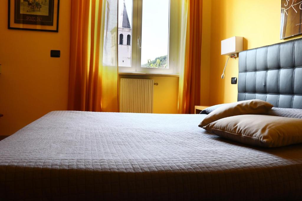 Postel nebo postele na pokoji v ubytování Hotel Clarici