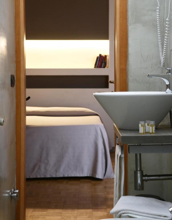 Postel nebo postele na pokoji v ubytování Hotel Clarici