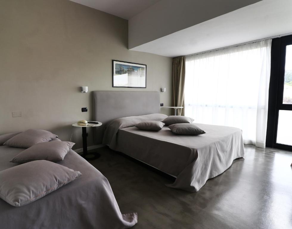 Postel nebo postele na pokoji v ubytování Hotel Clarici