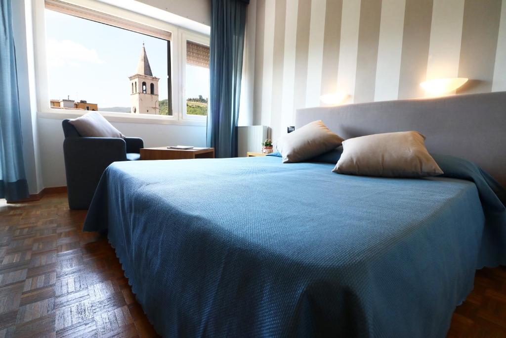 Postel nebo postele na pokoji v ubytování Hotel Clarici